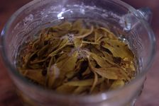 Yellow leaves infused in a glass of water in Yi Wu