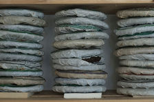 Stack of puerh <span class='translation'>(Pu Er tea)</span> on the shelf of an amateur