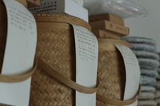  puerh <span class='translation'>(Pu Er tea)</span> cakes stored in bamboo boxes for long term