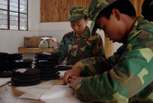 Hommes et femmes emballant des galettes chez Kucong Shan Zhai