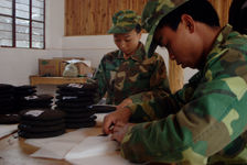 Men and women racing at a factory in Jinuo Shan