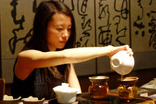  Young woman inusant a cup of puerh